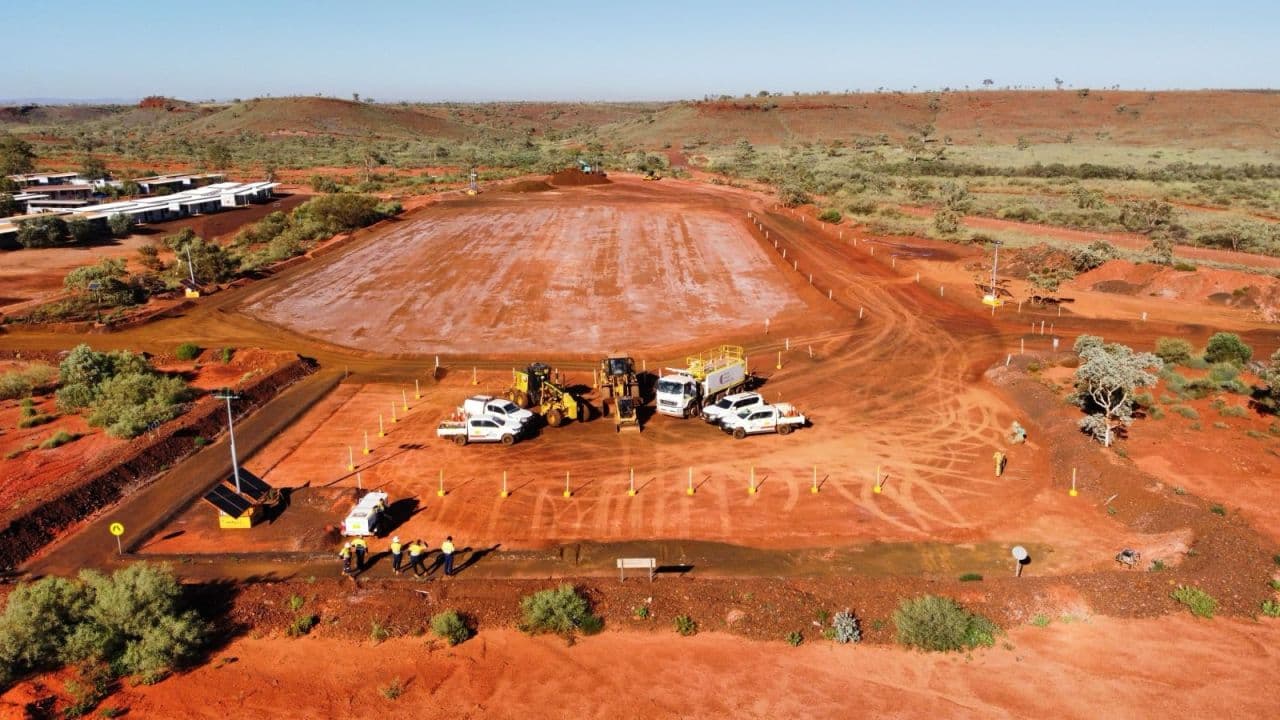 Aerial view of a large earthworks pad with plant and site vehicles staged
