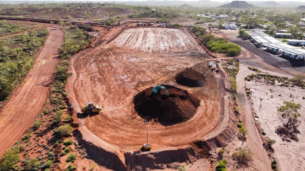 Aerial view of a large bulk earthworks pad beside a WA town site