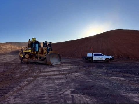 Dozer working a formed haul road at dusk